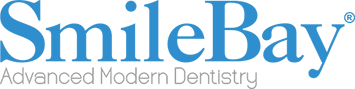 This image reflects the personalized care at SmileBay Dental, where a patient is guided through her treatment results by a professional dentist. Such one-on-one consultations are essential for helping patients understand their dental journey and feel confident in their smile transformation.