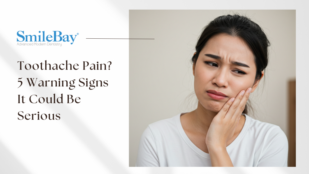 Asian woman with a painful expression holding her cheek, showing signs of a toothache – possible dental issue highlighted by SmileBay Dental.